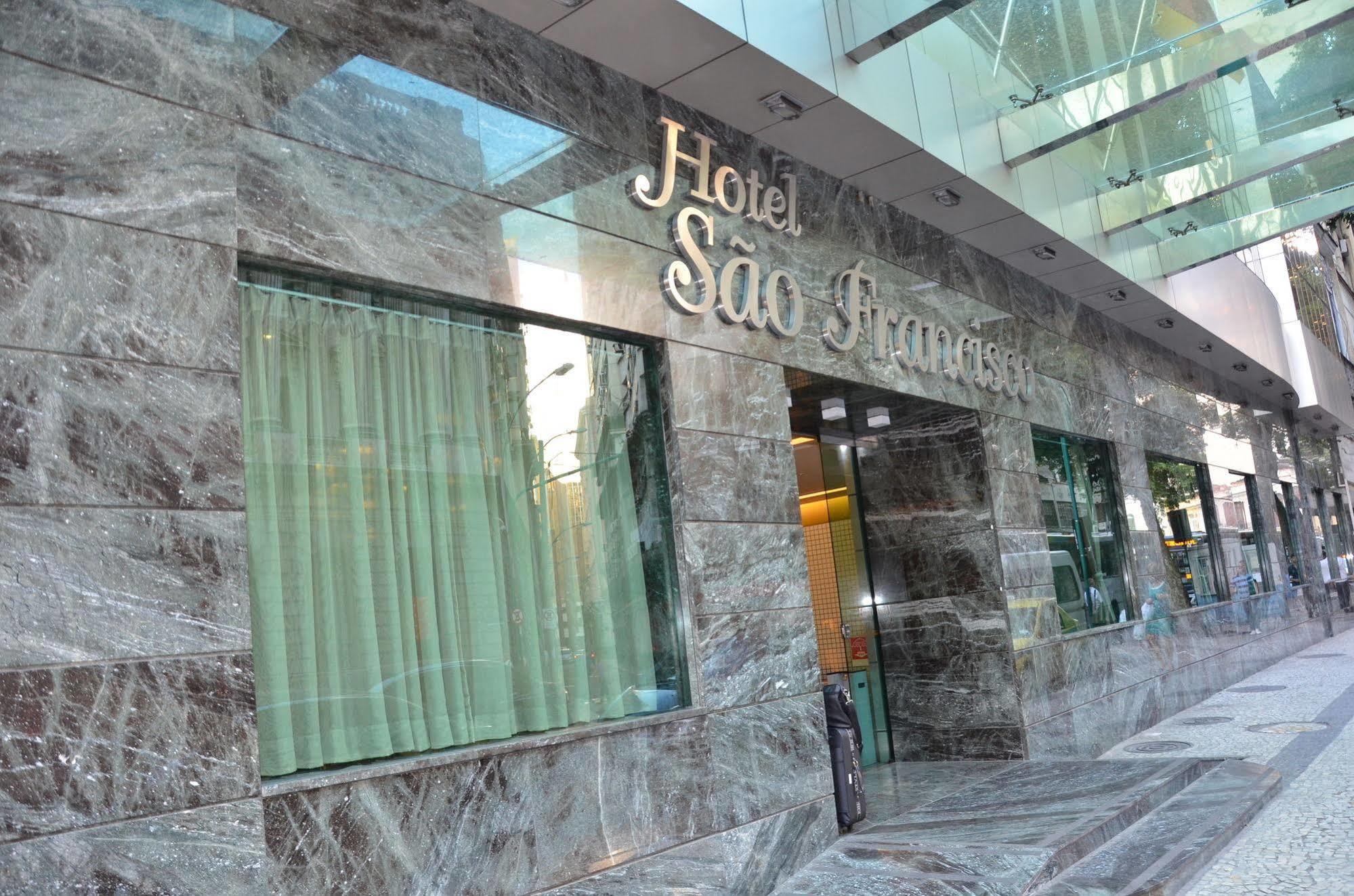 Hotel Atlantico Tower Rio de Janeiro Exteriör bild The photo shows the exterior of a hotel named "Hotel São Francisco." The facade is made of marble, giving it an elegant appearance, and large glass windows are visible, likely allowing natural light to enter the interior. There are light green curtai